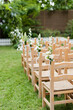Wooden chairs with flowers wedding ceremony