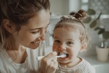 Fototapeta  - Caucasian mother brushing teeth baby toddler. Cosy bathroom with natural light, mom and child happy and playful atmosphere. Hygiene for children, childcare. Daily routine