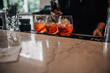 Bartender Adding Finishing Touch to Three Aperol Spritz Cocktails