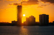 sunset over the city sun buildings in construction miami