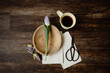 Serene flatlay with tulips and morning coffee on wood.