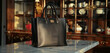 A stylish leather tote bag in classic black, sitting elegantly on a marble countertop, exuding sophistication and versatility