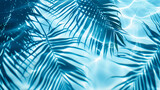 Fototapeta  - A blue palm leaves reflected in the water. Tropical leaf shadow on water surface. Shadow of palm on blue water. Beautiful abstract background