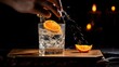 The delicate art of expressing orange zest over the glass reveals its citrus oils, captured in exquisite detail. Bartender adding an orange zest juice to a golden cocktail in the glass