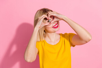 Sticker - Photo of adorable pretty lady dressed yellow t-shirt showing arms heart cover eye isolated pink color background