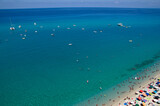 Fototapeta Sport - Sea beach with turquoise water and sand where people relax