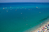 Fototapeta Kwiaty - Sea beach with turquoise water and sand where people relax