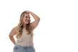 Caucasian plus-size young woman laughs, hand on head, looking sideways on white, copy space