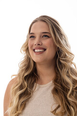 Wall Mural - A young Caucasian plus-size model with white background looks up, copy space