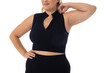 Caucasian plus-size young woman in black sportswear poses confidently on white bg