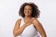 A biracial plus size model with curly brown hair laughs on white background, copy space