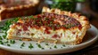 A slice of quiche Lorraine, its savory custard filling and flaky crust making for a hearty and satisfying meal.