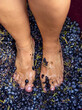 Women's legs stomp grapes during vendemmia, old traditional winemaking method in Italy