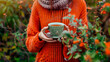 herbal tea in the hands of a woman in the garden. Selective focus.