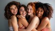 © liliyabatyrova - Four women with different hair colors and styles are hugging each other