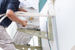 Repairman service for repair and maintenance of air conditioners, Technician team install new air conditioner
