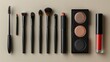 Makeup brushes and eye shadow palette, mascara, eyeliner, lipstick on beige background