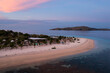 Labuan Bajo, Indonesia: Dramatic sunset over bungalows on an idyllic beach on a small islolated island near Komodo in Flores in Indonesia