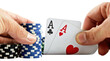 Hands holding poker chips and two aces cards isolated on transparent background.