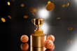 Gold cup on a pedestal with a basketball ball and coin confetti. 3d rendering