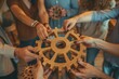 © VICHIZH - Diverse group of people holding a wooden cogwheel together in their hands for teamwork and collaboration concept