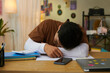 © DragonImages - Tired school boy fell asleep at his desk while preparing for exams