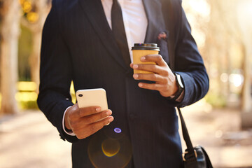 Canvas Print - Hand, phone and text on road, coffee and communication with company, New York and travel to office. Street, suit and person with mobile, professional and online for connection of publicist outdoor