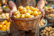 Vendor proudly presents a basket full of fresh, organic potatoes at a local farmers market, symbolizing small business and sustainable agriculture