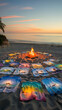 Circle of artistic t-shirts around campfire on beach during sunset