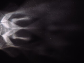 Wall Mural - light reflected on a steel surface in the dark for an abstract background, energy or mystery.