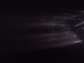 Wall Mural - light reflected on a steel surface in the dark for an abstract background, energy or mystery.