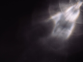 Wall Mural - light reflected on a steel surface in the dark for an abstract background, energy or mystery.