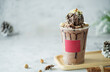 Chocolate milk shakes with cinnamon, chocolate pieces and various spices on stone background.