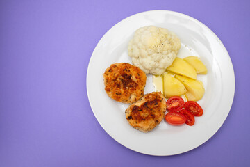 Poster - Fried chicken meatballs with boiled vegetables on white plate