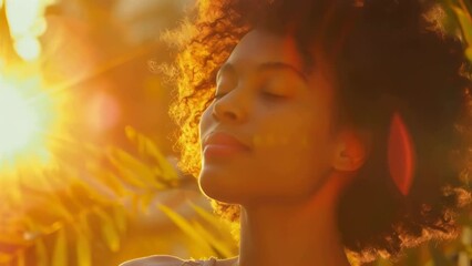 Wall Mural - A woman with curly hair is sitting in the sun