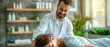 © Ahmad Soleh - Man doctor chiropractor or osteopath fixing lying woman back in manual therapy clinic