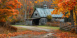 Rustic barn in the midst of autumn foliage on a country road, capturing the essence of fall