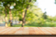 Wooden table top on blur nature bokeh green park background. Empty Wooden tabletop used for advertising products or products