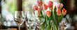 tulips and wineglasses Bouquet of tulips in bloom - mothers day, springtime and international women's day concept. Brighten up your home with flowers.
