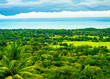 Verdant landscape of the Pacific Coast in Costa Rica, with lush rainforest transitioning into tranquil blue waters under a dynamic sky. High quality photo