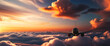 Airplane flying over beautiful clouds at sunset.