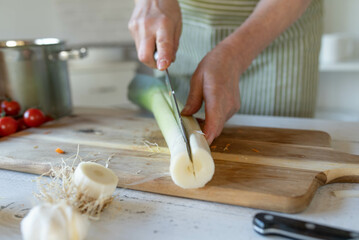 Wall Mural - Cutting leek the long way to clean it properly