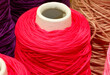 ball of wrapped red thread and other colors in the warehouse of the knitting factory
