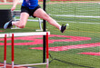 Female running in a hurdle race outdoor