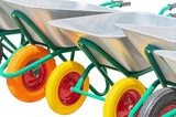 Fototapeta Zwierzęta - Garden metal wheelbarrow carts isolated on white