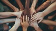 © Hamid - A group of diverse people joining their hands together in unity and support seen from a top down view Ai generated