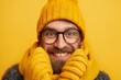 Person in yellow knit hat covering face