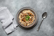 Risotto with champignon mushrooms on a gray concrete background. View from above. Italian food.