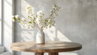 Stylish Scandinavian minimalistic interior with round wooden table and vase with white flowers