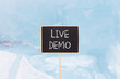 © Dzmitry - Live demo symbol. Concept words Live demo on beautiful yellow black blackboard. Beautiful blue ice background. Copy space. Business and live demo concept.